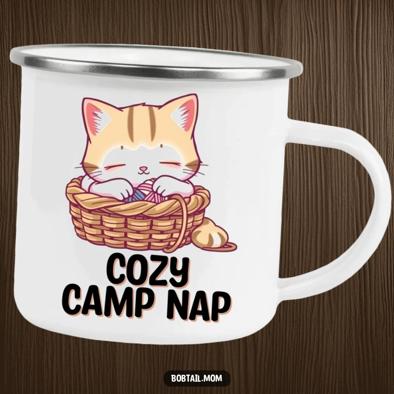 Funny camping mug featuring a Bobtail cat peacefully napping in a knitting basket, a durable and humorous companion for outdoor relaxation.