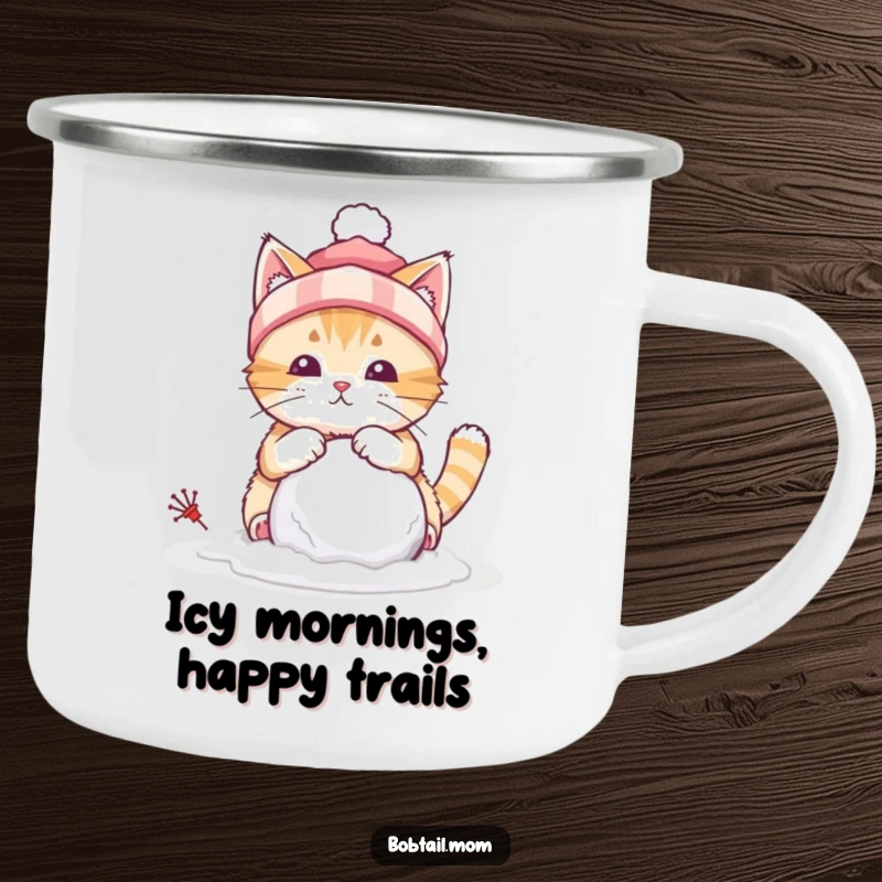 Funny camping mug featuring a bobtail cat wearing a winter hat, building a tiny snowball, ideal for winter outings.