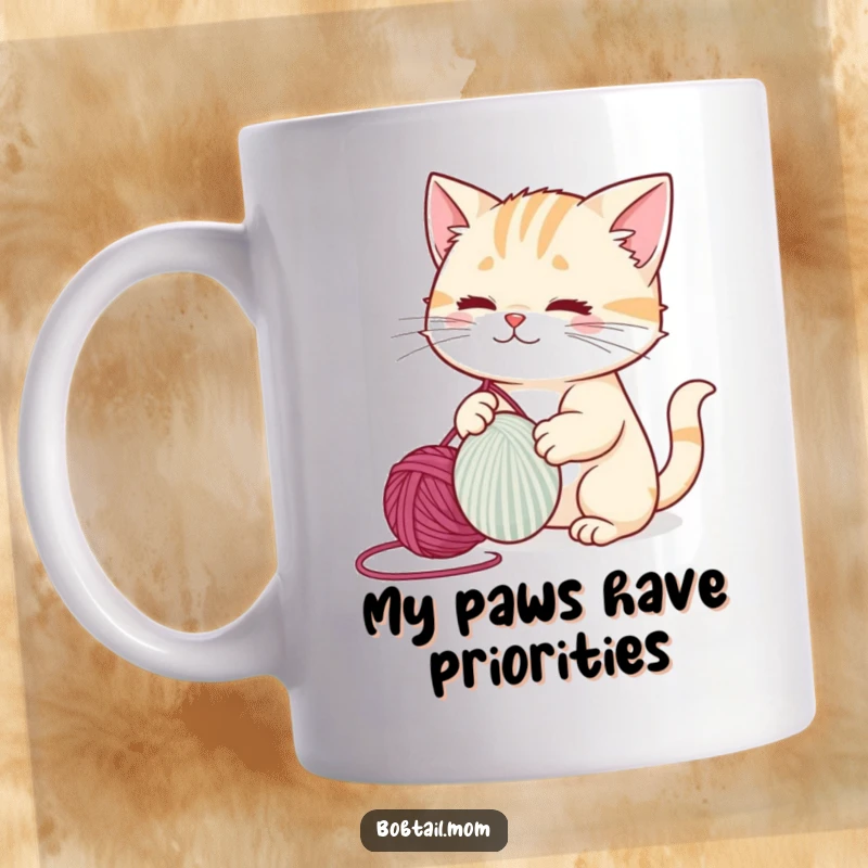 Funny bobtail cat batting a big yarn ball, showing playful curiosity and mischief, perfect for a cat lover's mug.