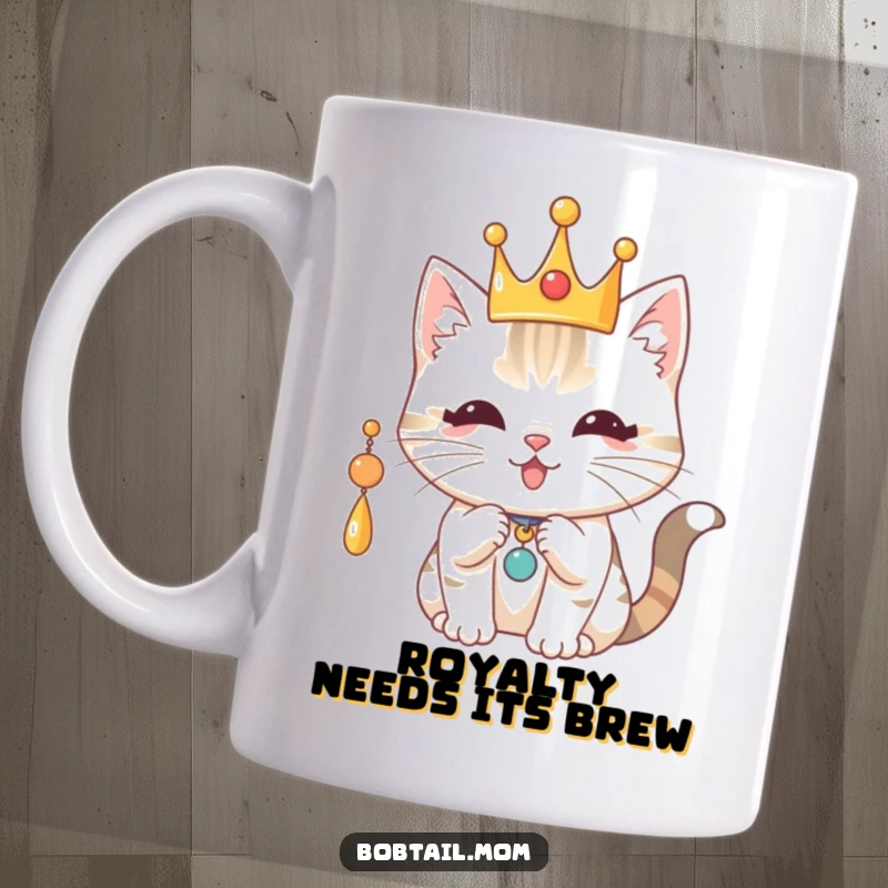 Funny Royal Bobtail Cat Mug: Cat wearing a crown, playfully batting a charm, exuding regal fun.
