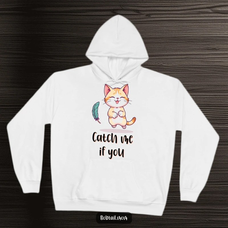 Funny Bobtail cat character hoodie, depicted mid-leap, playfully pursuing a feather toy, offering cozy cat-themed comfort.