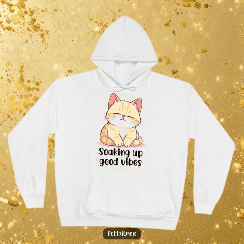 Funny Bobtail cat enjoying a contented sigh while napping in a warm sunbeam, printed on a cozy hoodie.