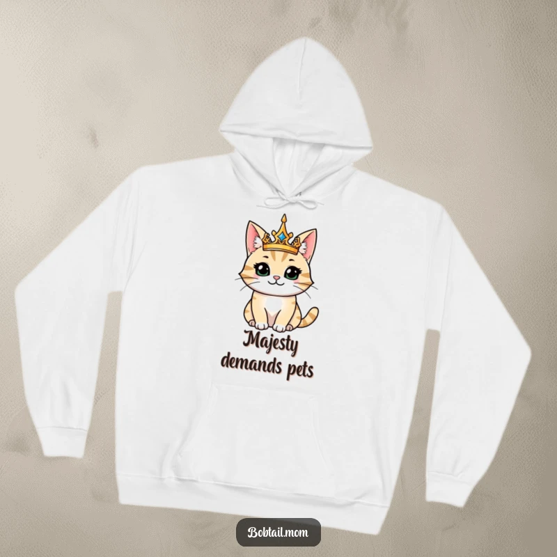 Funny hoodie featuring a majestic bobtail cat wearing a crown, looking regal and happy, perfect for lounging in comfort.