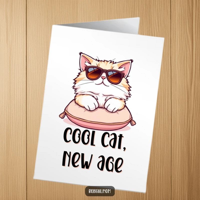 Funny Free Printable Birthday Card: Fluffy Bobtail cat in oversized sunglasses lounging coolly on a tiny cushion, looking chill.