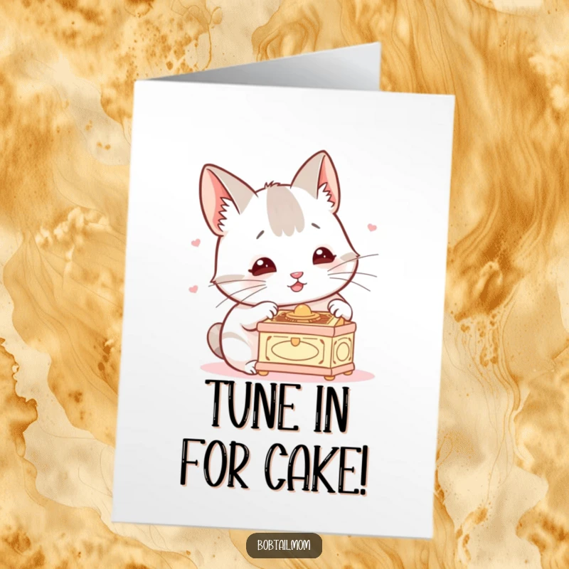 Funny Free Printable Birthday Card: A Bobtail cat with twitching ears intently listens to a tiny music box, showing pure concentration.