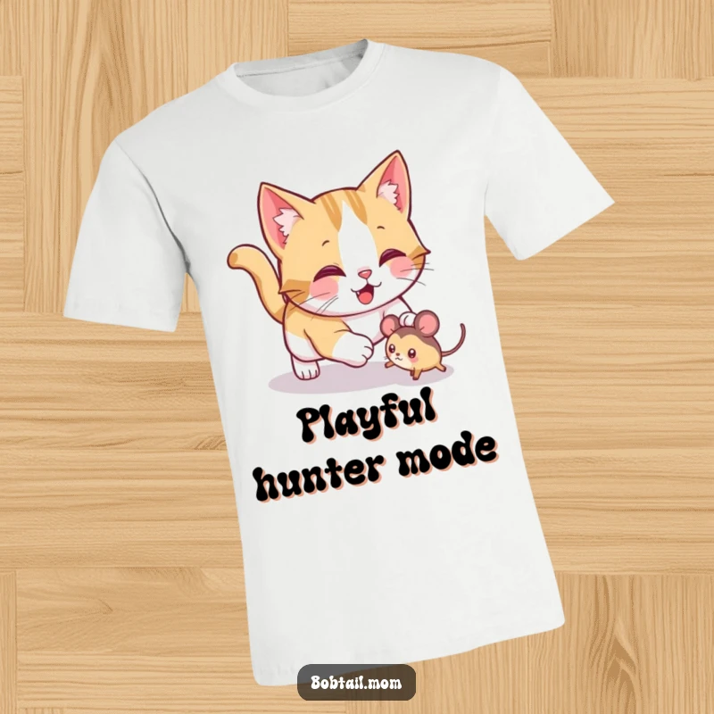 Funny Bobtail cat t-shirt featuring a jolly cat playfully pouncing on a toy mouse, perfect for expressing playful feline energy.