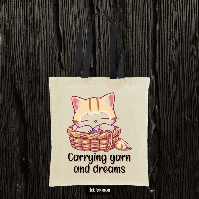 Funny tote bag featuring a Bobtail cat peacefully napping in a knitting basket, ideal for craft supplies and everyday use.