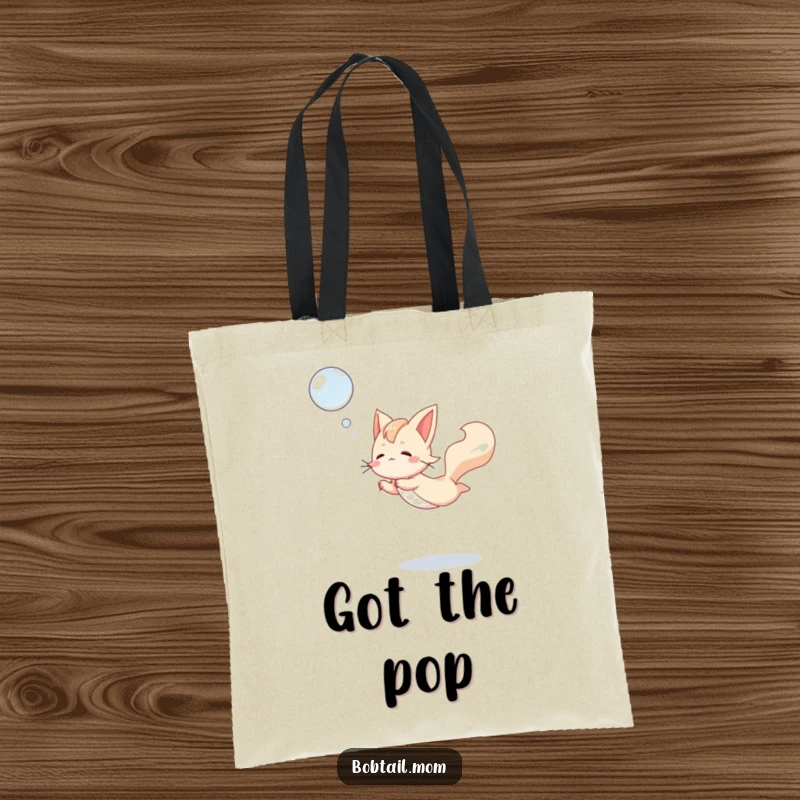 Funny Bobtail Tote Bag featuring a dog mid-leap, gracefully catching a bubble, a humorous and practical accessory for play enthusiasts.